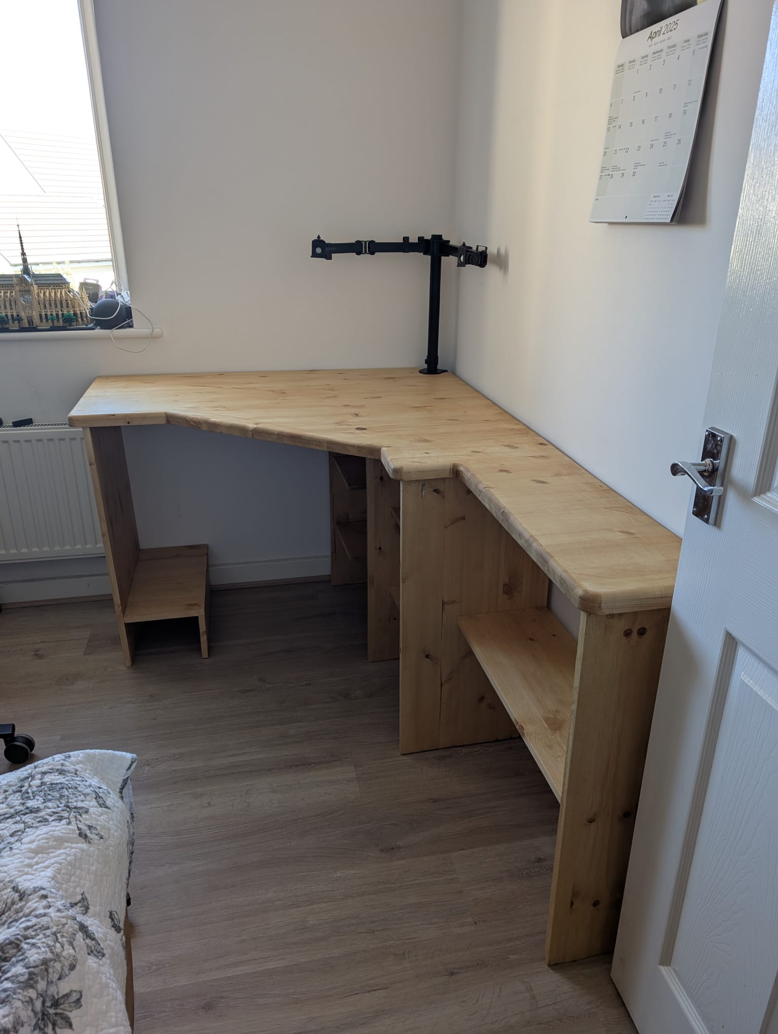 The Croyde Desk seen from the side, with the long 2,400mm arm running off into the room and an open shelf along the return for books and box files.