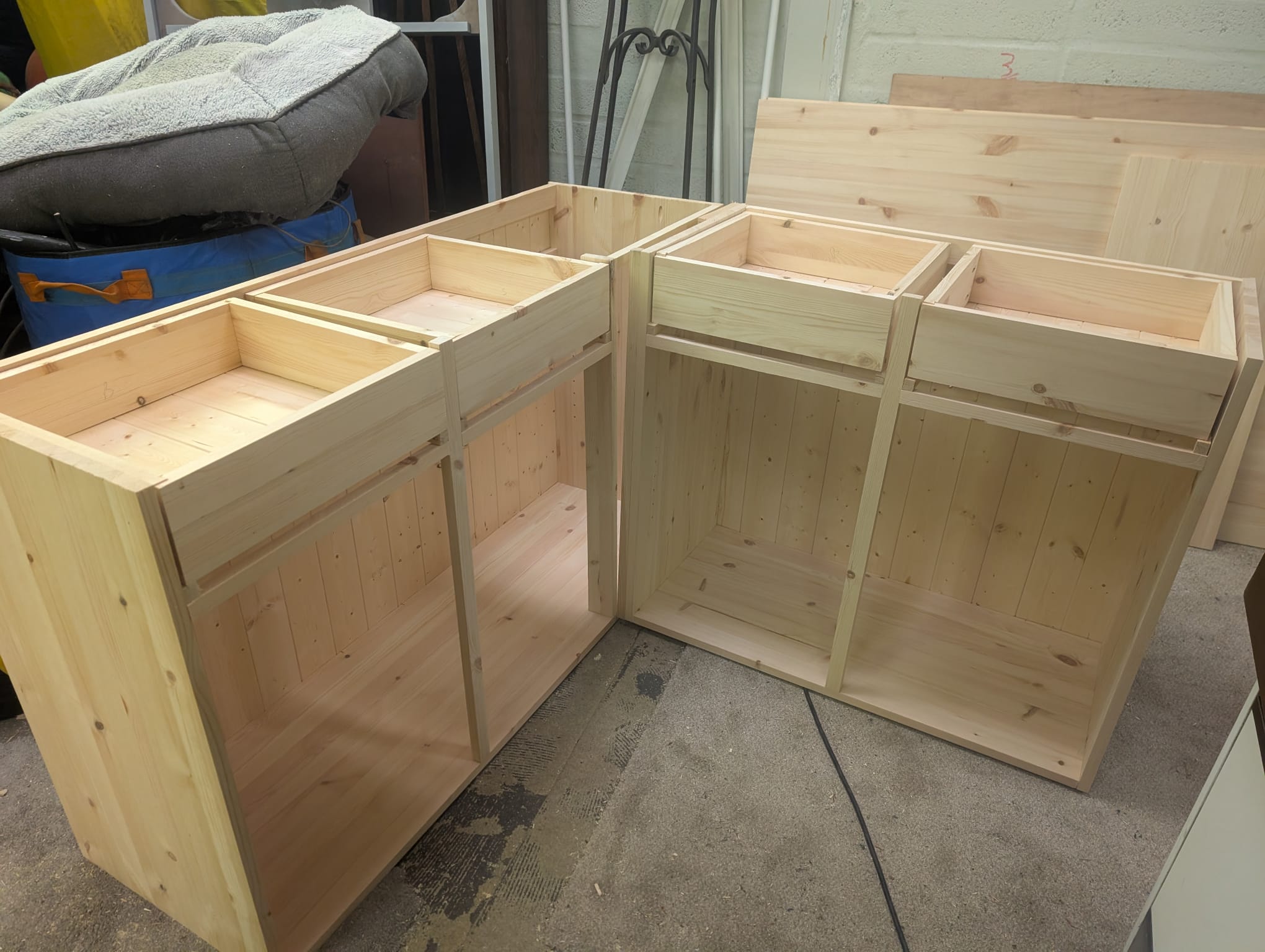 The two carcasses for the dresser part-built — drawer rails set into solid pine sides with tongue-and-groove panelled backs and a centre upright.