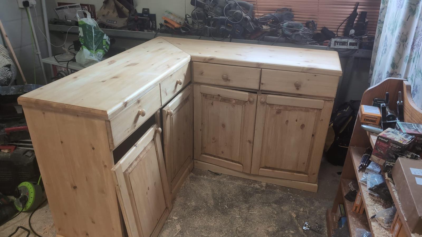 The L-shaped base of the Torridge Dresser stood in the workshop, with drawers and panelled cupboard doors fitted, before the plate dresser was added on top.